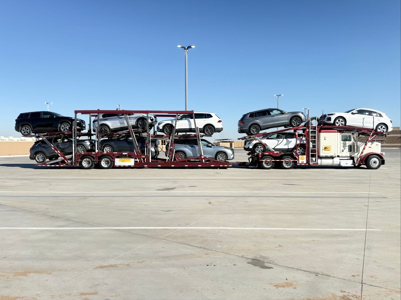 Great West Auto loaded Cottrell car hauler in a staging lot